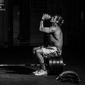 Muscular athlete drinking from a shaker