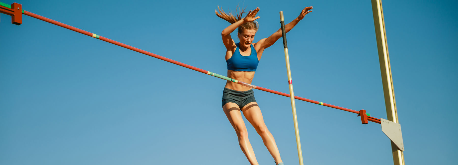 Young athlete performing a Pole jump attempt